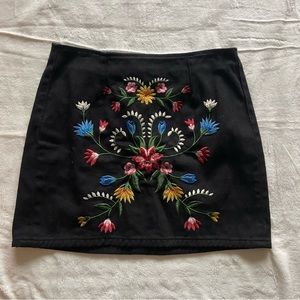 Black jean skirt with embroidered floral design
